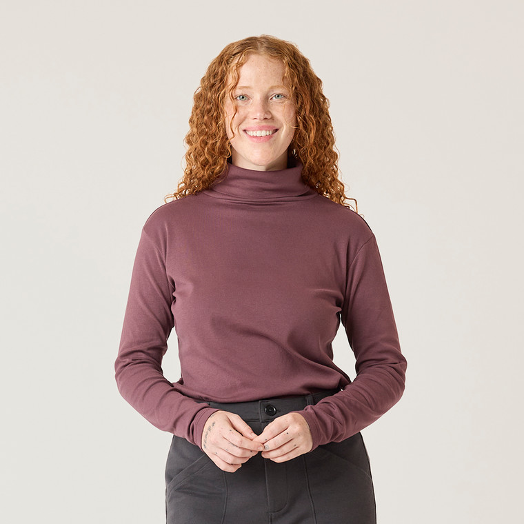 Close up front view of model wearing organic cotton turtleneck in color plum.