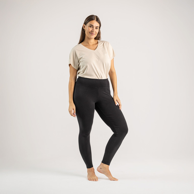 Full body front view of model wearing organic cotton ribbed leggings.