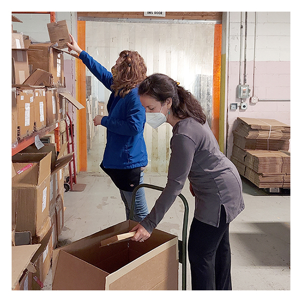 Maggie's Organics staff packing products for donation to Ukrainian refugees